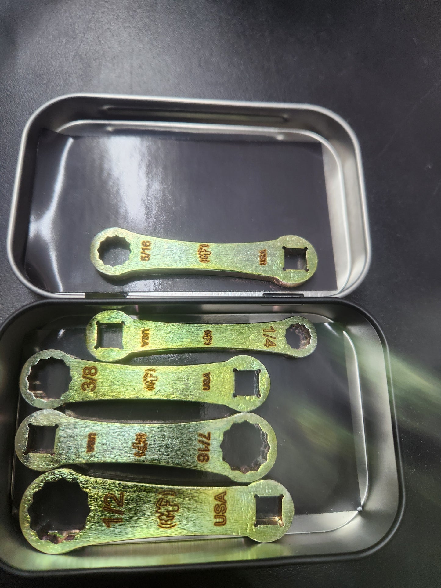 Custom etched tin to contain tools. 